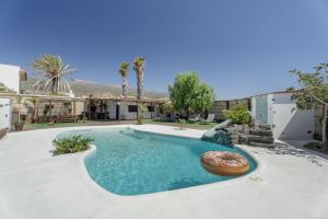 a swimming pool with a donut in the middle at Casa Abuelo Manuel in El Draguito