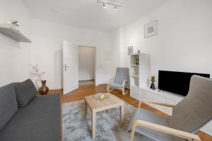 a living room with a couch and a tv at Ferienwohnung Merzig in Merzig