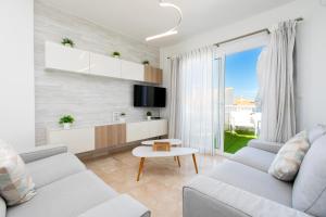 a living room with a couch and a tv at Luxury Sea view Apartment in Nerja