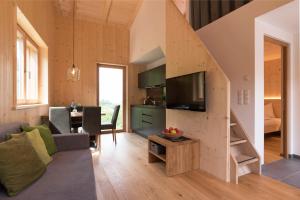 a tiny house with a staircase and a living room at Greiterhof in Lana