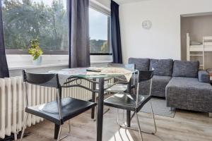 a living room with a table and chairs and a couch at Hansa Nest in Hamburg