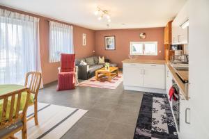 a kitchen and living room with a couch and a table at Haus Ruther - Wohnung 2 in Bad Saulgau