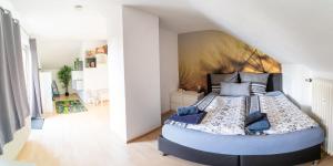 a bedroom with a large bed in a room at Seeblick Wadee in Radolfzell am Bodensee