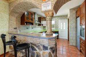 a kitchen with a large stone island in the middle at Casa rural cavila in Pliego