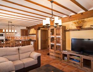 a living room with a couch and a flat screen tv at Montes De Alhama in Villarraso