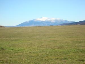 a large field with a snow covered mountain in the background at Montes De Alhama in Villarraso