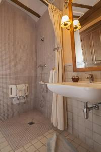 a bathroom with a sink and a shower at Montes De Alhama in Villarraso +11 photos