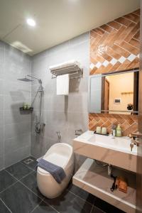 a bathroom with a toilet and a sink at Weal Apartment in Danang