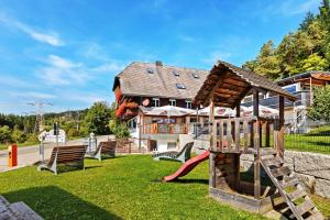 a playground in front of a house at Mettmapark - Chalet 2 in Grafenhausen