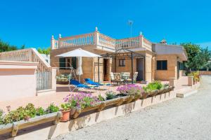 a house with a wooden deck with plants and flowers at Ses Llegitimes in Marratxí 