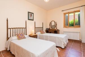 a bedroom with two beds and a window at Ses Llegitimes in Marratxí  +29 photos
