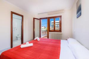 a bedroom with a large bed with a red blanket at Cas Bunyoler in Cala Ratjada +25 photos