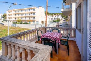 a balcony with a table and chairs and a street at Cas Bunyoler in Cala Ratjada