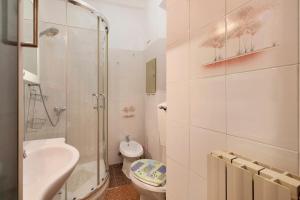 a bathroom with a shower and a toilet and a sink at A due passi dal mare in Pietra Ligure +11 photos