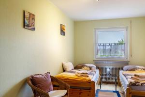 a room with two beds and a window at Ferienwohnung Sigrun in Niedenstein