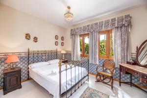 a bedroom with a bed and a desk at Villa Tramontana in Lloseta +20 photos
