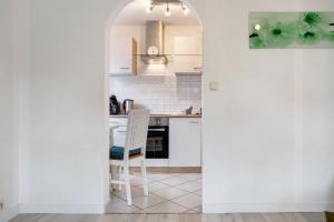 a kitchen with an archway leading into a kitchen with a table at Bäckerhus - Ferienwohnung 5 in Wiek auf Rügen