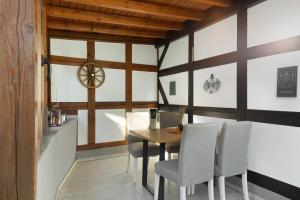 a dining room with a wooden table and chairs at Ferienwohnung am Hügel in Schmallenberg +25 photos