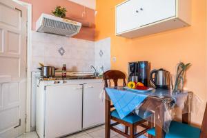 a small kitchen with a table and a sink at Veroni's studio 1 in Vathi