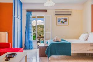 a hotel room with a bed and a window at Veroni's studio 1 in Vathi +12 photos