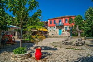 a town square with a red vase and a building at Sunset Sea View Cottage in Nea Potidaea