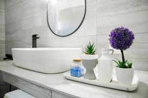 a bathroom counter with a sink and a mirror at Sunset Sea View Cottage in Nea Potidaea +27 photos