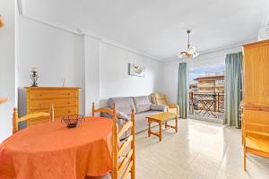 a living room with a table and a couch at Viñamar 7 in La Mata