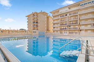 a large swimming pool in front of a building at Viñamar 7 in La Mata