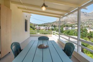 a blue table and chairs on a balcony at Stunning Views Kantouni Beach in Kalymnos