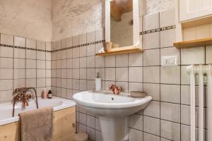 a bathroom with a sink and a bath tub at Baita Al Rossat in Sant’Orsola +23 photos