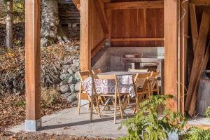 a table and chairs sitting inside of a house at Baita Al Rossat in Sant’Orsola