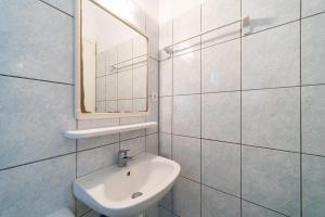a white bathroom with a sink and a mirror at Arianna Studio 12 in Paleokastritsa +18 photos