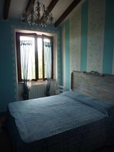 a bedroom with a bed in front of a window at Mare Colline Città d'Arte in Rosignano Marittimo