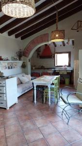 a living room with a table and a couch at Mare Colline Città d'Arte in Rosignano Marittimo +37 photos