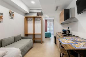 a living room with a couch and a kitchen at I Tramonti Del Golfo - Kennedy in Balestrate