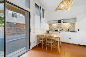 a kitchen and dining room with a table and chairs at U Canetta 2 in Pietra Ligure +6 photos