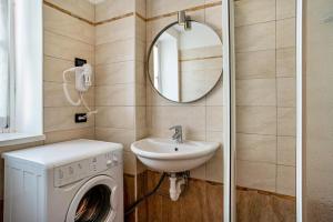 a bathroom with a washing machine and a sink at Casa Batistei Ribes in Molveno +31 photos