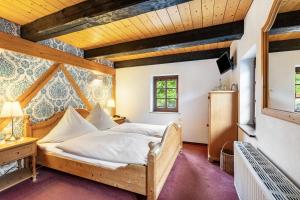 a bedroom with a bed in a room with wooden ceilings at Weingut Schuh in Coswig