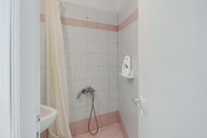 a bathroom with a shower curtain and a sink at Politimis Studio N7 in Amorgos