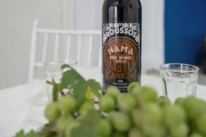 a bottle of wine sitting on a table with glasses at Politimis Studio N7 in Amorgos +23 photos