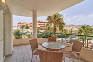 a balcony with a table and chairs and a view at Beachfront apartment Torrox Costa in Torrox