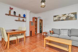 a living room with a couch and a table at Beachfront apartment Torrox Costa in Torrox