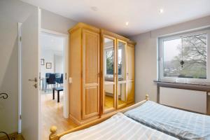 a bedroom with a wooden cabinet and a bed at Ferienwohnung Keil in Balve