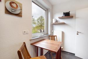 a small dining room with a table and a window at Ferienwohnung Keil in Balve +12 photos