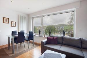 a living room with a couch and a table and a large window at Ferienwohnung Keil in Balve