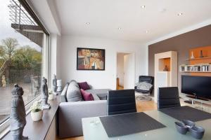 a living room with a couch and a tv at Ferienwohnung Keil in Balve