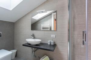 a bathroom with a sink and a shower at New Eleven Apartment on Como Lake in Oliveto Lario +26 photos