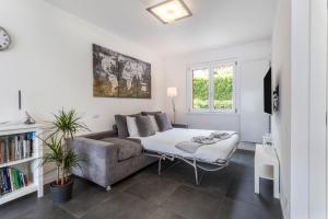 a living room with a couch and a table at New Eleven Apartment on Como Lake in Oliveto Lario