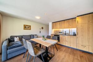 a living room with a couch and a table at Sunnseitn Lodge Apartment Alps in Moso