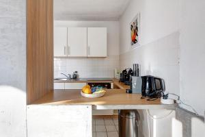 a kitchen with a bowl of fruit on a counter at Domus Lux 404 in Bad Säckingen +21 photos